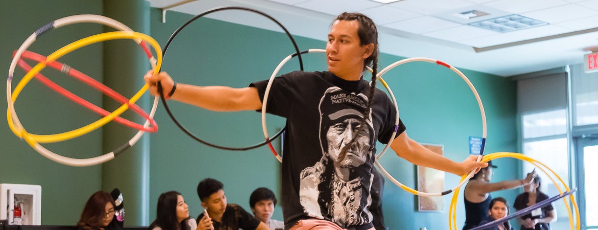 A NASP student performs using multiple hoops
