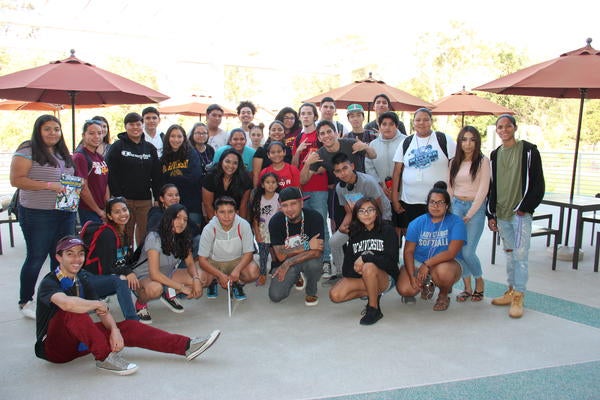 A crowd of NASP students pose outside of UCR's Highlander Union Building (HUB)