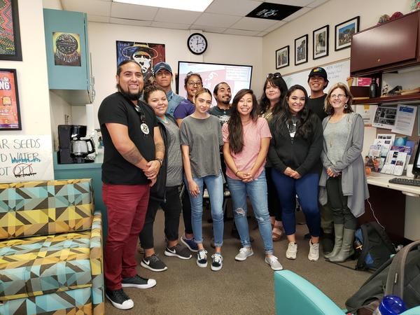 Staff members and students stand shoulder to shoulder in the NASP office at UC Riverside