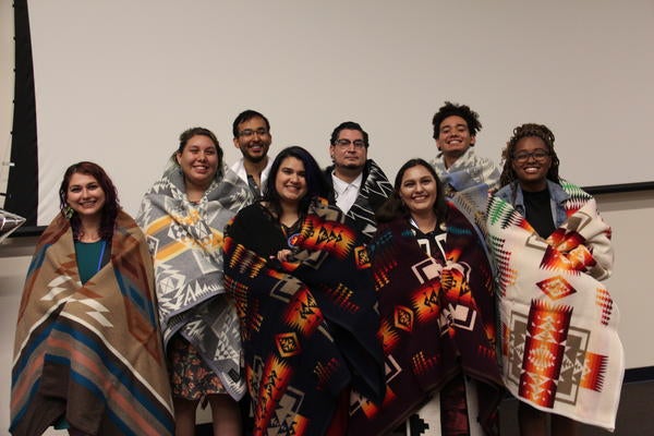 Eight NASP graduates wear Native blankets