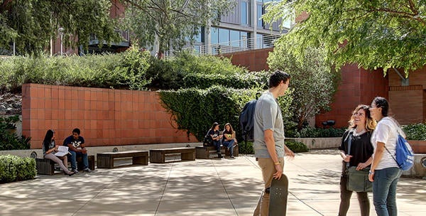 Students chat and study on the sunny campus of UC Riverside