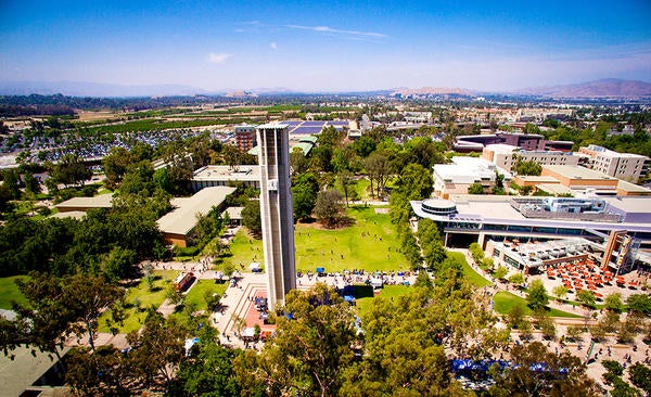 An aerial photo of UC Riverside, featuring its iconic bell tower in the middle of campus