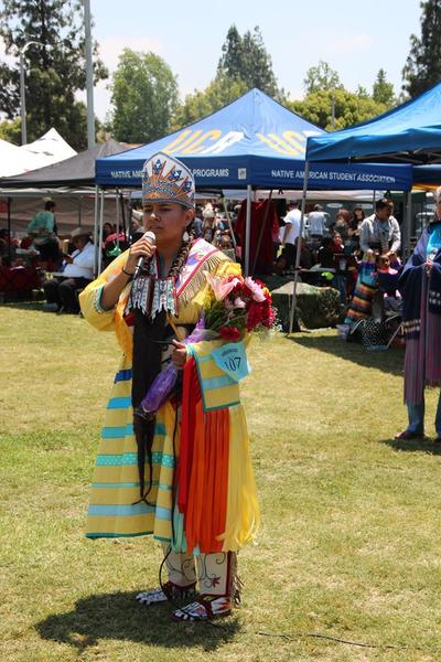 2019-20 UCR Pow Wow Princess addresses onlookers while standing in front of the NASP tent