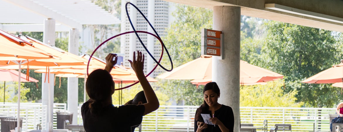 A NASP student spins two hoops in the air, just outside UCR’s Highlander Union Building (HUB)